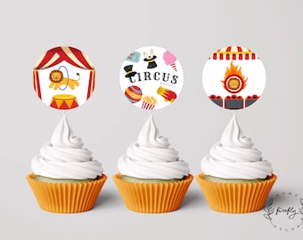 May include: Three cupcake toppers with a circus theme. The toppers feature a lion in a circus tent, a magician's hat, a cotton candy cone, and a lion in a ring of fire. The text "Circus Birthday" is on one of the toppers.