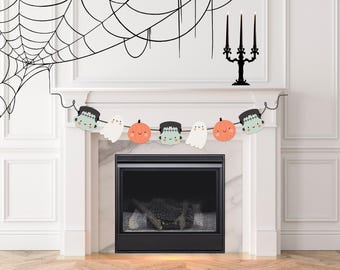 May include: A Halloween-themed mantelpiece decoration featuring a black spiderweb, a garland with cartoon ghosts, pumpkins, and Frankenstein's monster, and a black candelabra with three candles. The fireplace is black.