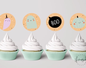 May include: Four cupcakes with orange and black Halloween themed toppers. The toppers feature a ghost, a pumpkin, a ghost with a witch's hat, and a speech bubble with the word "BOO".
