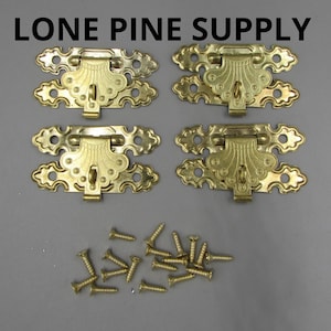 May include: Four ornate brass-colored clasps with decorative designs, along with a collection of matching screws. The clasps are arranged in two rows of two, with the screws scattered below. The text "LONE PINE SUPPLY" is at the top.