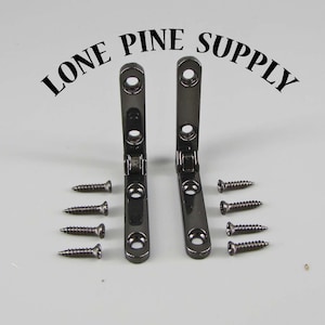 May include: Two black metal corner brackets with eight black screws. LONE PINE SUPPLY is printed in black above the brackets.