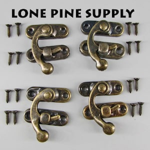 May include: Four antique brass hook and eye clasps with screws. Each clasp has a hook with a rounded end and a flat eye. The clasps are arranged in two rows of two.