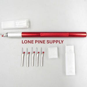 May include: A sewing kit with a red seam ripper, several silver seam rippers with red tips, and two clear plastic cases. The text "LONE PINE SUPPLY" is printed on the image.