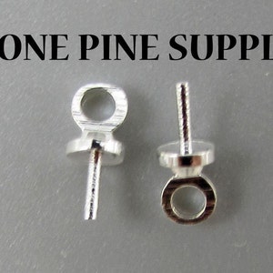 May include: Two silver-toned bead tips with a loop at the top and a pin at the bottom.  The bead tips are designed to be used for making jewelry.