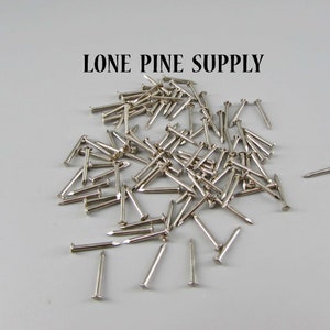 May include: A pile of silver-colored tacks or small nails. LONE PINE SUPPLY is written in black text at the top of the image.
