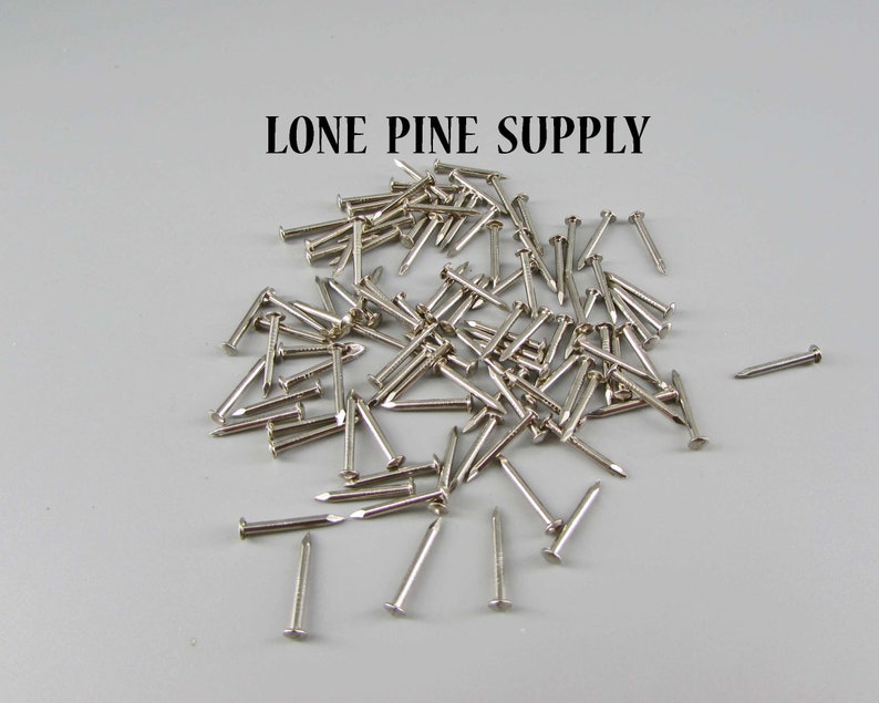 May include: A pile of silver-colored tacks or small nails. LONE PINE SUPPLY is written in black text at the top of the image.