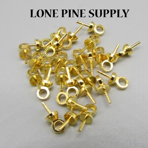 May include: A pile of gold-colored metal bead tips with a loop at the top and a post at the bottom.  Lone Pine Supply.