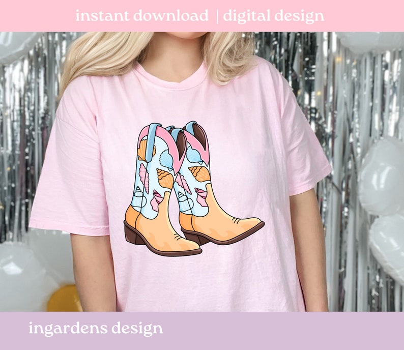 May include: A light pink t-shirt featuring a graphic of two cowboy boots. The boots are tan with blue and pink accents, and are decorated with seashell illustrations. The text "instant download | digital design" is at the top.