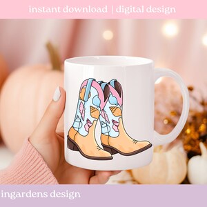 May include: White ceramic mug featuring a colorful illustration of cowboy boots decorated with ice cream cones and seashells. The mug has a curved handle and the text "instant download | digital design".