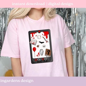 May include: A pale pink t-shirt with a graphic design featuring a black frame and red blood splatter. The design includes a book, knife, bat, skull, coffin, and the text "HORROR Book Club". The words "instant download | digital design" are at the top.