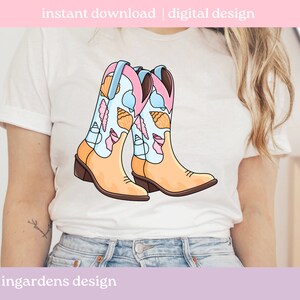 May include: A pair of cartoon cowboy boots with a light tan base and brown heels. The boot shafts are light blue and decorated with seashells in pink, tan, and white. The text "instant download | digital design" is at the top. The text "ingardens design" is at the bottom.