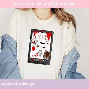 May include: Cream-coloured t-shirt with a graphic of a black tablet displaying horror-themed illustrations, such as a book, knife, and skull. The tablet reads "HORROR BOOK CLUB". The words "instant download | digital design" are at the top.