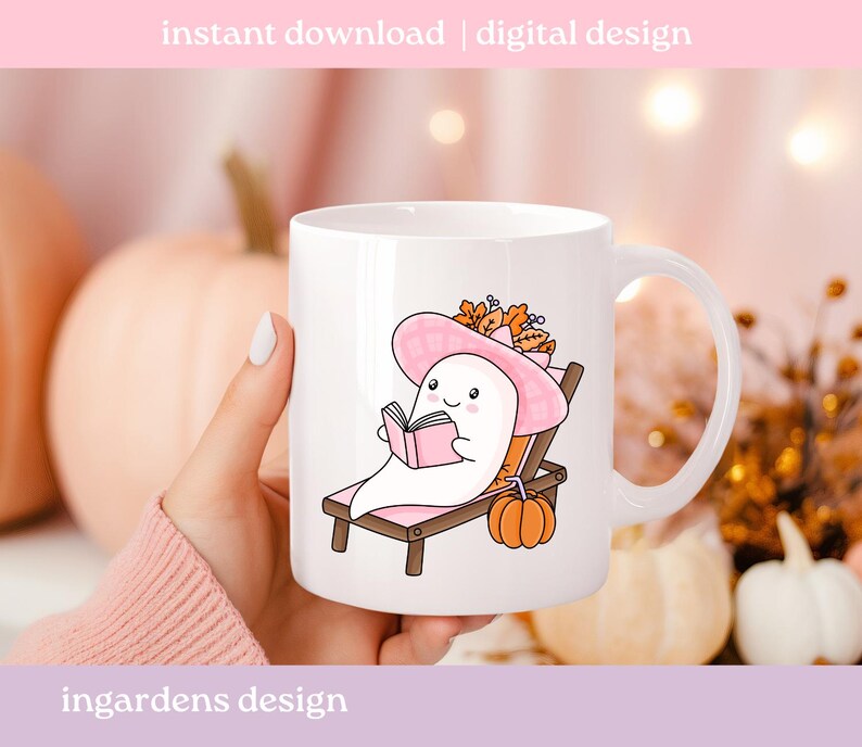 May include: White ceramic mug featuring a cartoon ghost relaxing on a beach chair, wearing a pink hat, and reading a book. A small orange pumpkin sits nearby. The mug has the text "instant download | digital design" and "ingardens design".