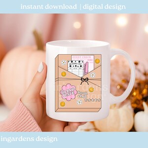 May include: White ceramic mug featuring a whimsical design for a book club. The design includes a pink envelope with a guest check, reading list, and the text "BLIND DATE book club". The mug is decorated with smiley faces and flowers.