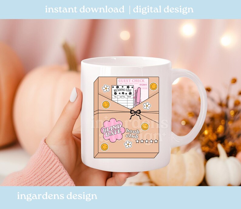 May include: White ceramic mug featuring a whimsical design for a book club. The design includes a pink envelope with a guest check, reading list, and the text "BLIND DATE book club". The mug is decorated with smiley faces and flowers.