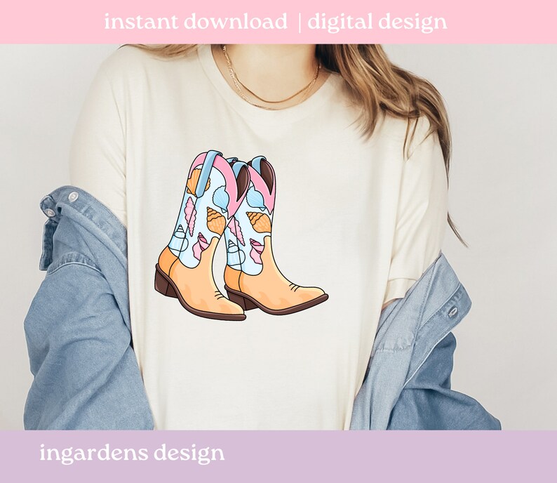 May include: A cream-colored t-shirt featuring a colorful illustration of cowboy boots. The boots are light tan with blue, pink, and white accents, and are decorated with seashells and feathers. Text at the top reads "instant download | digital design".