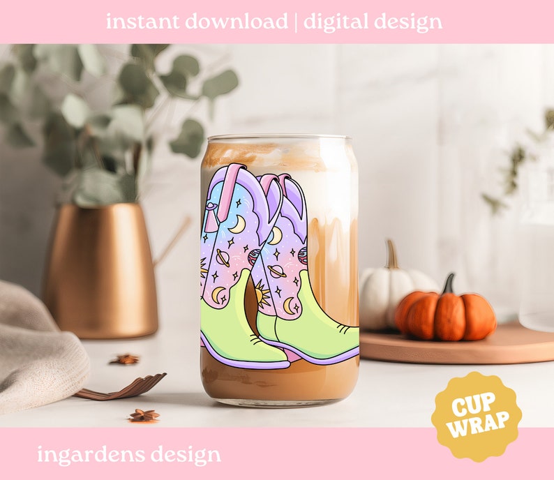 May include: A digital design for a cup wrap featuring a pair of colourful cowboy boots with a celestial pattern. The boots are on a light brown background with the text "CUP WRAP" in a yellow circle.