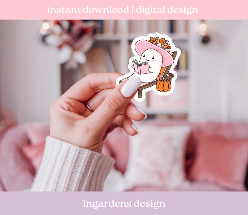 May include: A sticker featuring a cartoon ghost wearing a pink hat and reading a book while relaxing on a beach chair. The sticker has a pumpkin and fall foliage. Text at the top says "instant download | digital design".