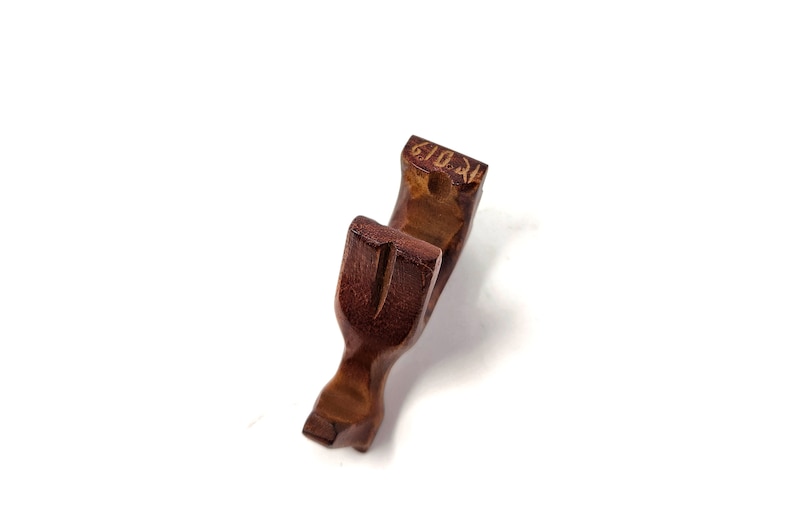 May include: A wooden, brown, U-shaped object with a carved design. The object is made of wood and has a smooth, polished finish.