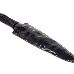 May include: A black obsidian knife with a dark grey handle. The knife is sharp and pointed, and the handle is wrapped in a dark grey material.