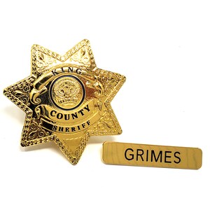 May include: Gold sheriff's star badge with the words "KING COUNTY SHERIFF" and a name tag that reads "GRIMES".