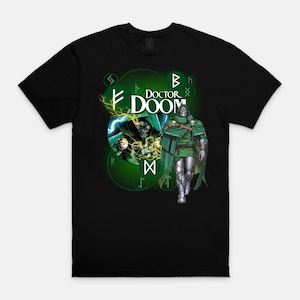 May include: A black short-sleeved t-shirt featuring a graphic of the character Doctor Doom. The design includes the text DOCTOR DOOM, a circular green background with glowing runes, lightning effects, and a full-body illustration of the character.