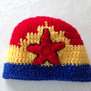 May include: A red, yellow, and blue crocheted hat with a red star in the center.