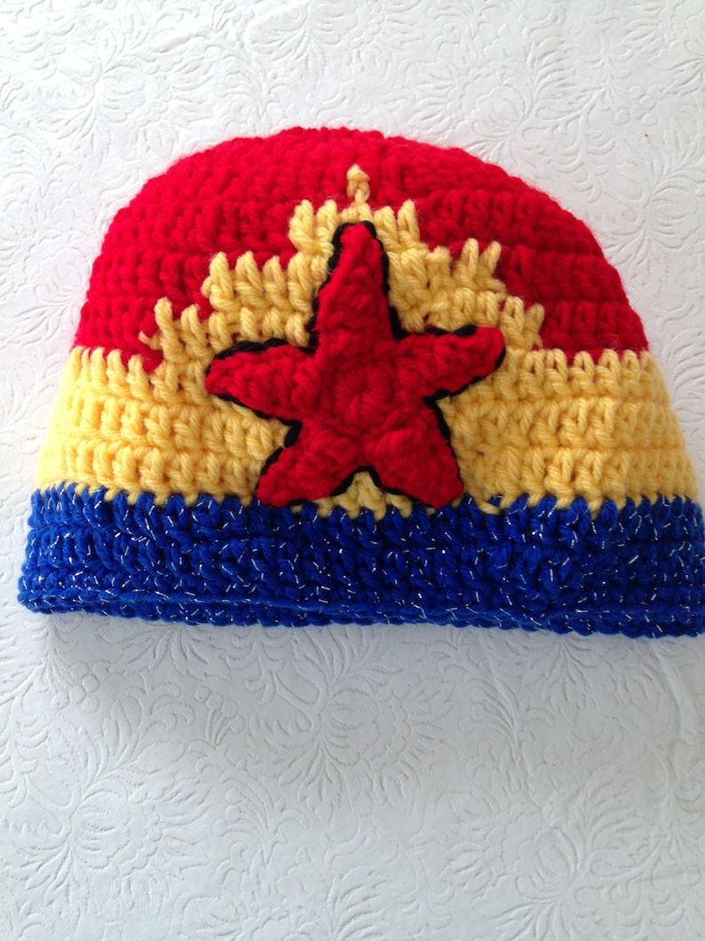 May include: A red, yellow, and blue crocheted hat with a red star in the center.