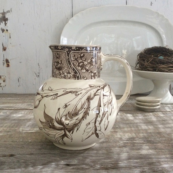 Antique brown transferware pitcher in the "Cactus" pattern