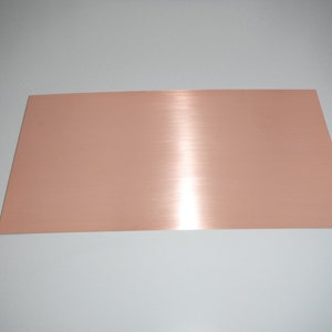 May include: A sheet of brushed copper metal with a warm, reddish-brown color.