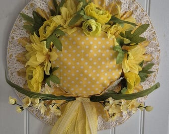 Flower hat wreath. Yellow wall hanging.