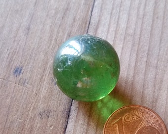 1920s HAND BLOWN MARBLE, transparent bottle green glass with air bubbles and pontil mark. Unique game of marbles collectors piece.