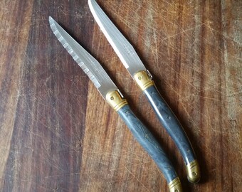Vintage French LAGUIOLE STEAK KNIVES, set of 2, with classic handles in marbled grey, serrated blade and famous bee symbol.