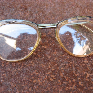 1950s VINTAGE FRENCH EYEGLASSES with silver metal browline mono top and clear plastic rims. True mid century eye wear collector project.