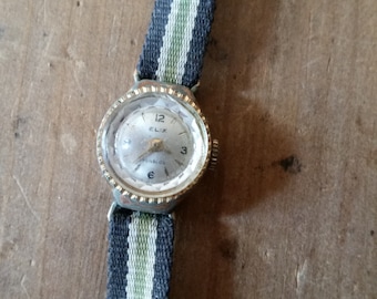 1940s French ELIX Gold Wrist Watch with cloth band. Wind up, analogue movement, Swiss Incabloc system. Small interior bevelled face.