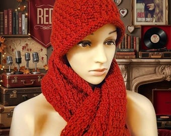 May include: A vibrant red chunky knit beanie hat with an integrated long scarf. The set features a thick, textured yarn construction with a folded brim on the beanie and a matching ribbed pattern throughout the scarf that drapes down the front.