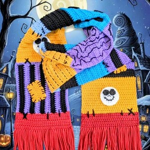 May include: A colorful, crocheted scarf featuring a patchwork design with black, blue, purple, orange, and red sections. The scarf has a fringed edge and a Jack Skellington face applique. The background shows a spooky Halloween scene.