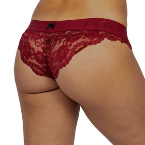 May include: Red lace underwear with a black bow and the word "FOX" on the waistband.