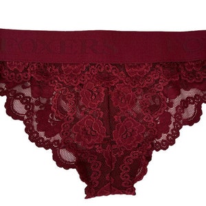 May include: Burgundy lace underwear with a wide elastic waistband.