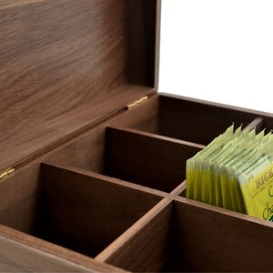 May include: A wooden tea box with six compartments, open to reveal a stack of Bigelow Cozy Chamomile tea bags.