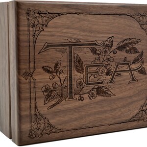 May include: A wooden tea box with an engraved design featuring the word "TEA" surrounded by leaves and flowers.