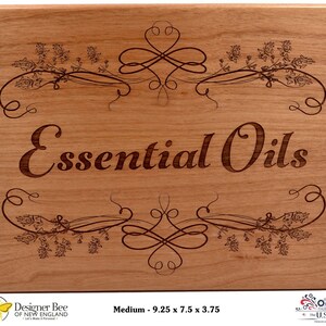 May include: A wooden sign with the words "Essential Oils" engraved in a decorative font. The sign is decorated with a floral design and has a medium size of 9.25 x 7.5 x 3.75 inches.