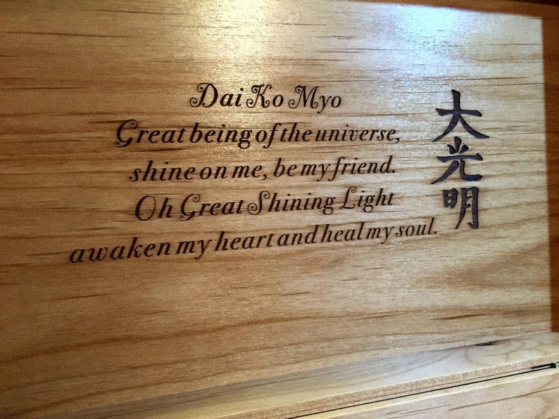 May include: A wooden box with an inscription that reads "Dai Ko Myo Great being of the universe, shine on me, be my friend. Oh Great Shining Light awaken my heart and heal my soul." The inscription is in English and Japanese.