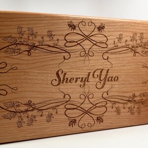 May include: A wooden box with a floral design and the name "Sheryl Yao" engraved on the front.