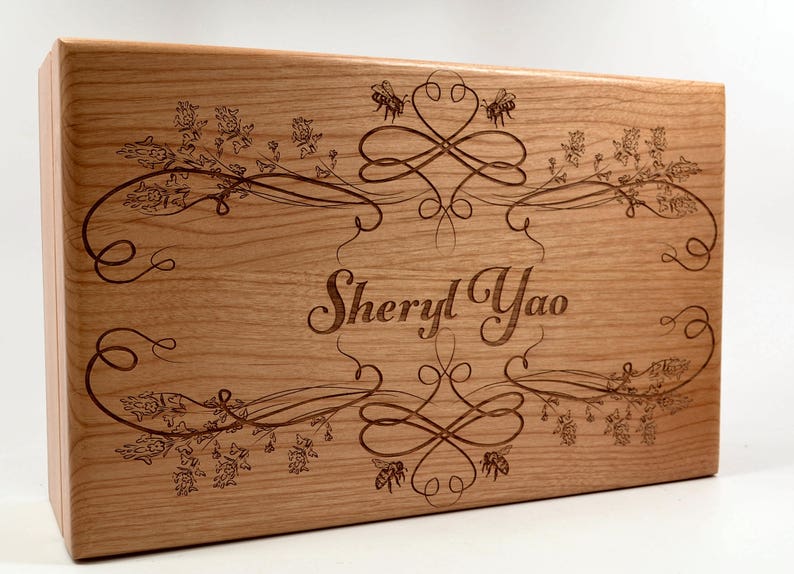 May include: A wooden box with a floral design and the name "Sheryl Yao" engraved on the front.