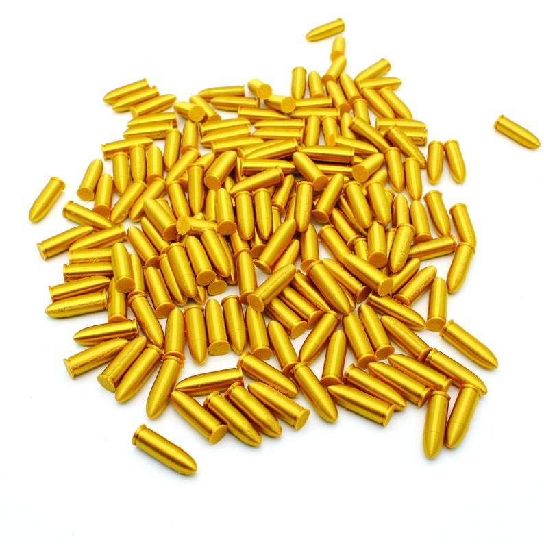 May include: A large pile of gold-colored bullet casings on a white background.