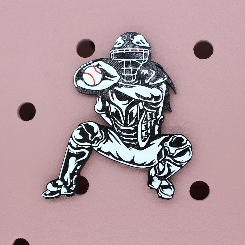May include: Black and white illustration of a baseball catcher in a crouching position, wearing a catcher's mask and holding a baseball.