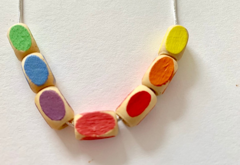 minimal style wooden statement necklace in rainbow colours. Geometric bead