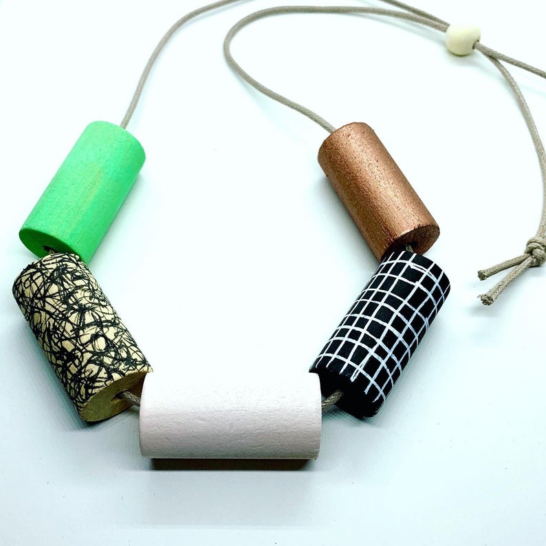 Statement monochrome pattern necklace with hand painted green and pale pink cylinder beads