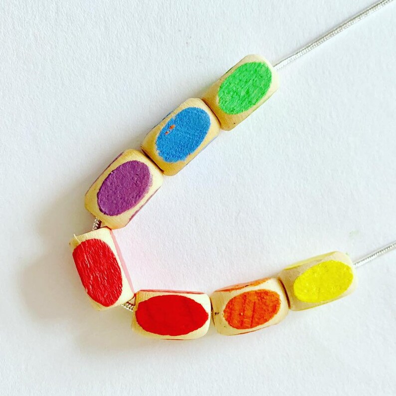 minimal style wooden statement necklace in rainbow colours. Geometric bead